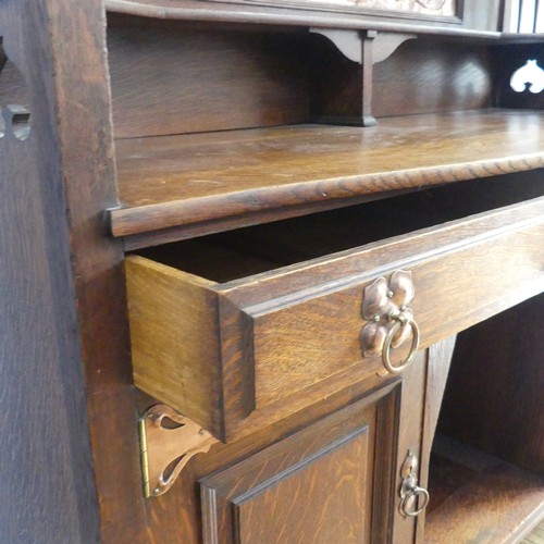 513 - A Shapland and Petter of Barnstaple Arts and Crafts oak Sideboard, the raised top with pierced flora... 