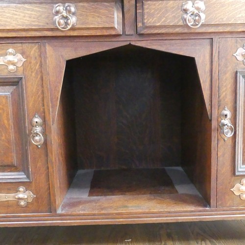 513 - A Shapland and Petter of Barnstaple Arts and Crafts oak Sideboard, the raised top with pierced flora... 