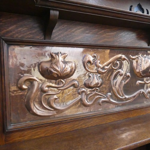 513 - A Shapland and Petter of Barnstaple Arts and Crafts oak Sideboard, the raised top with pierced flora... 