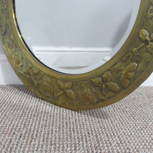 528 - An Arts and Crafts brass asymmetrical Mirror, in the style of the Keswick School of Industrial ... 