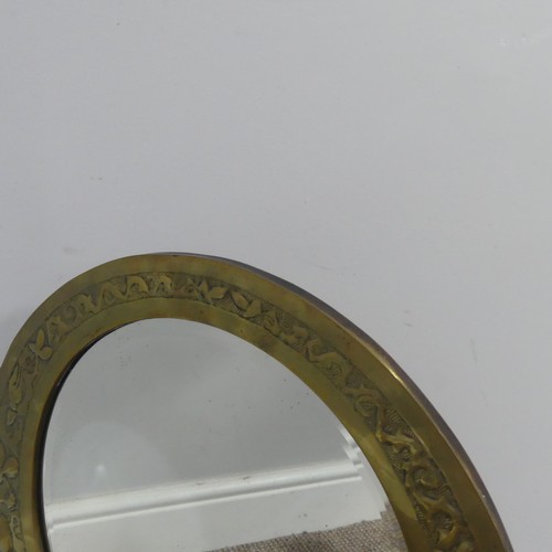 528 - An Arts and Crafts brass asymmetrical Mirror, in the style of the Keswick School of Industrial ... 