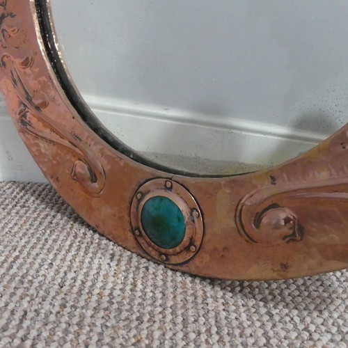 526 - In the manner of Liberty & Co an Arts and Crafts circular copper Mirror, the studded and hammere... 