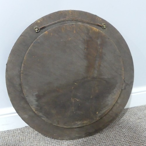 526 - In the manner of Liberty & Co an Arts and Crafts circular copper Mirror, the studded and hammere... 