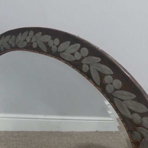 533 - An unusual Arts and Crafts copper Mirror, possibly by Hugh Wallis, the oval copper frame decorated w... 