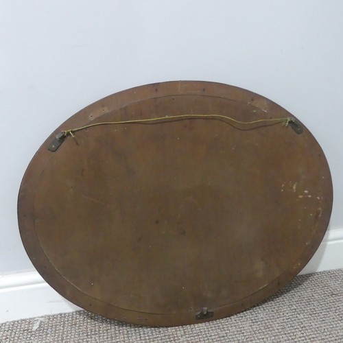 533 - An unusual Arts and Crafts copper Mirror, possibly by Hugh Wallis, the oval copper frame decorated w... 