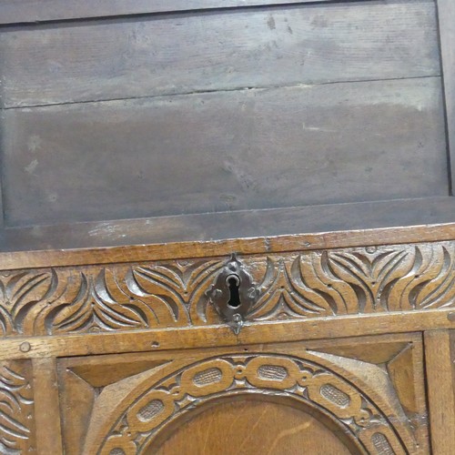 668 - A 19th century carved oak Coffer, raised on square supports, W 124 cm x H 60 cm x D 48.5 cm.... 