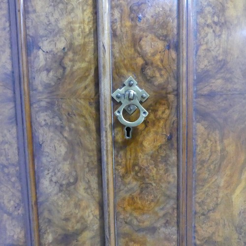 561 - A Victorian burr walnut compactum Wardrobe, the moulded cornice over two doors concealing interior w... 