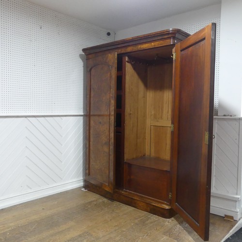 561 - A Victorian burr walnut compactum Wardrobe, the moulded cornice over two doors concealing interior w... 