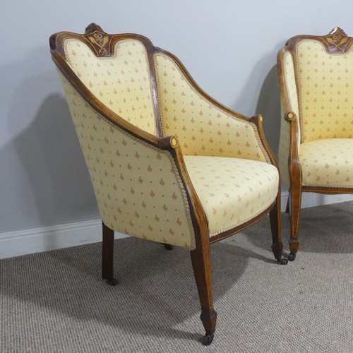 612 - A pair of Edwardian upholstered show-frame Armchairs, with scrolled arms, raised on tapering support... 