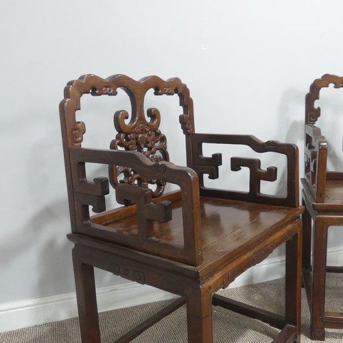 568 - A pair of late 19th/early 20th century Chinese carved hardwood Armchairs, with scrolled top rails ab... 