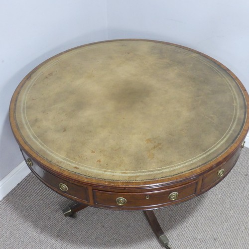 598 - A Regency mahogany revolving drum Table, of small proportions, the circular top inset with green gil... 