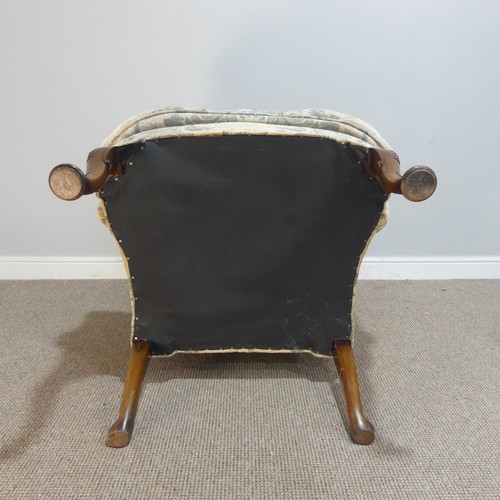 587 - A George II style upholstered wing Armchair, the shaped top over seat, flanked by scrolled arms, rai... 