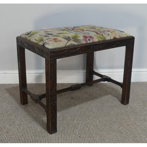 590 - A George III style oak framed Stool, the upholstered seat raised on square carved supports, united b... 