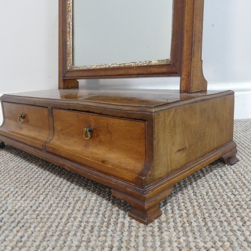 583 - A Georgian mahogany dressing table swing Mirror, the beveled mirror plate encased in carved giltwood... 