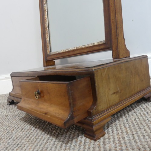 583 - A Georgian mahogany dressing table swing Mirror, the beveled mirror plate encased in carved giltwood... 