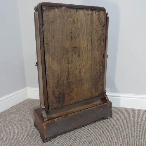 577 - A George III mahogany dressing table swing Mirror, the beveled mirror plate encased in carved giltwo... 