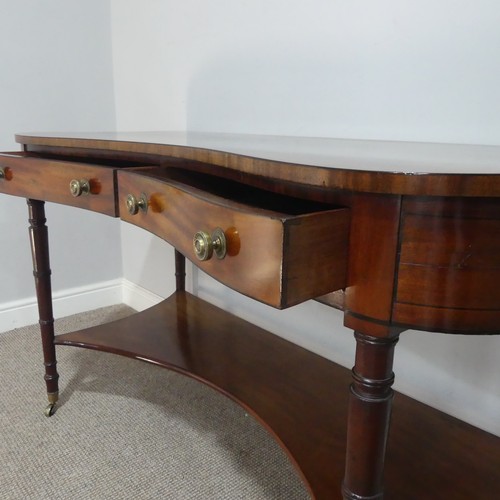 580 - An early 19th century mahogany kidney-shaped dressing/side Table, inlaid with ebony stringing, the k... 