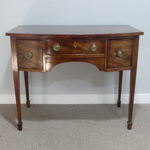 582 - A Regency mahogany bow-front side Table/Desk, of small proportions, the shaped top above three drawe... 