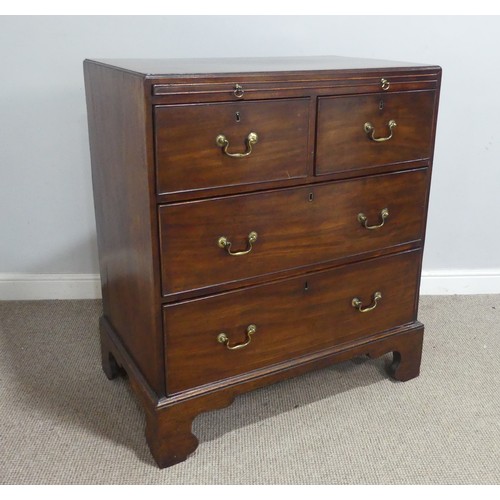 586 - A Georgian mahogany bachelor's Chest of drawers, fitted with brushing slide over two short and two l... 