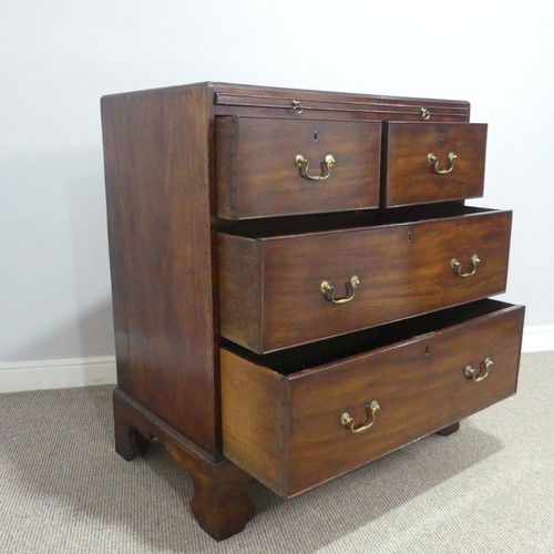 586 - A Georgian mahogany bachelor's Chest of drawers, fitted with brushing slide over two short and two l... 