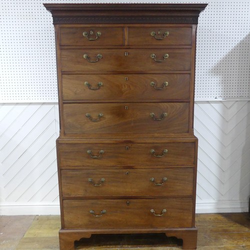 573 - A George III mahogany Chest on Chest, the upper section with a carved and moulded cornice and frieze... 