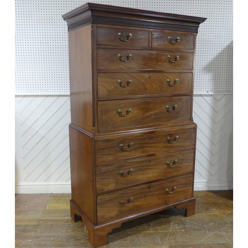 573 - A George III mahogany Chest on Chest, the upper section with a carved and moulded cornice and frieze... 