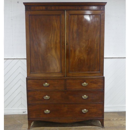 585 - A Regency mahogany Linen Press, the upper section with moulded cornice over paneled doors, concealin... 