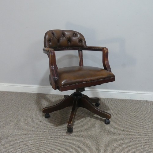 593 - An antique style leather captains desk Chair, raised on swivel base and castors, W 59 cm x H 82 cm x... 