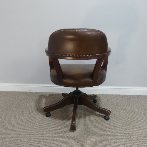 593 - An antique style leather captains desk Chair, raised on swivel base and castors, W 59 cm x H 82 cm x... 