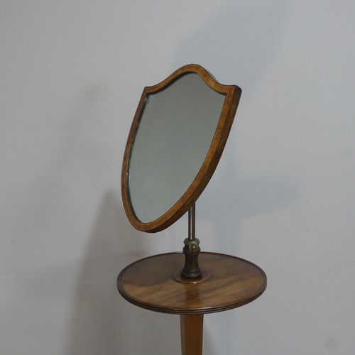 629 - A Georgian mahogany Shaving Stand, the shield swing mirror on telescopic stand, raised on tripod tab... 