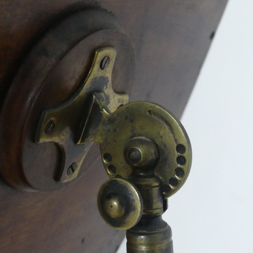 629 - A Georgian mahogany Shaving Stand, the shield swing mirror on telescopic stand, raised on tripod tab... 