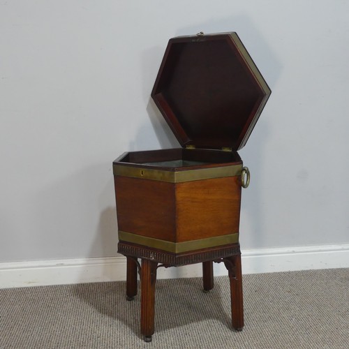 610 - A George III mahogany hexagonal brass bound Cellarette, the hinged lid opening to a lead lined inter... 