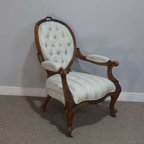 616 - A mid-Victorian carved walnut upholstered Armchair, raised on carved cariole supports, W 66 cm x H 9... 