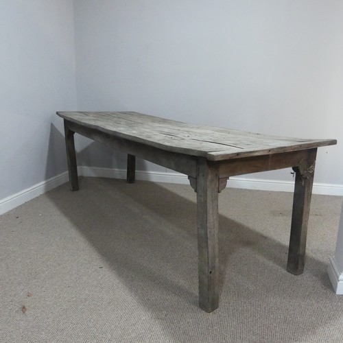 620 - A 19th century French elm weathered kitchen farmhouse Table, the four panel top with cleated ends, r... 