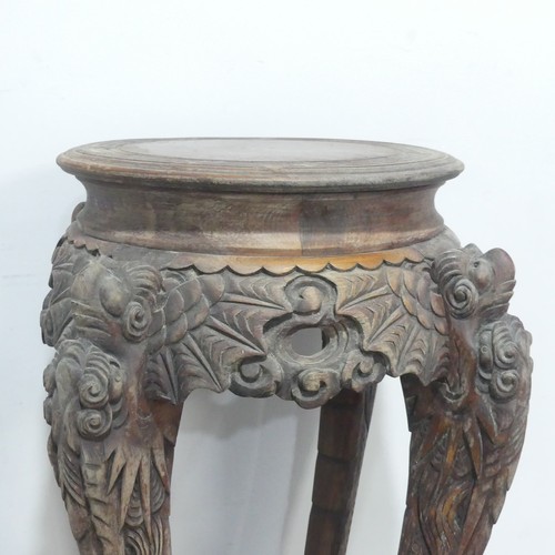 673 - An antique Chinese carved hardwood Plant Stand, the circular top with geometric carved border, raise... 