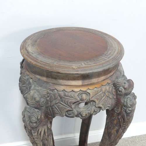 673 - An antique Chinese carved hardwood Plant Stand, the circular top with geometric carved border, raise... 