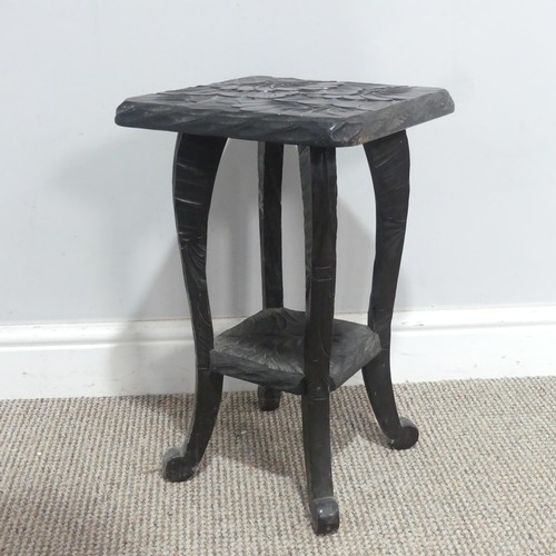 641 - A Liberty & Co Japanese two-tier side Table, carved with sunflower motif and marked to the under... 