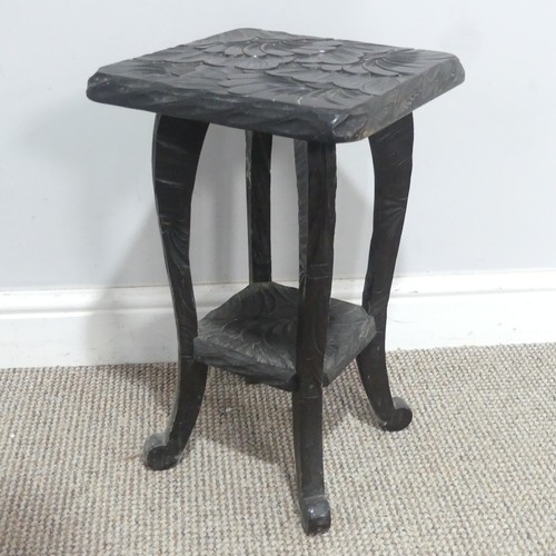 641 - A Liberty & Co Japanese two-tier side Table, carved with sunflower motif and marked to the under... 