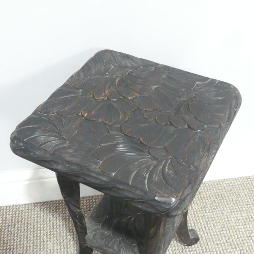 641 - A Liberty & Co Japanese two-tier side Table, carved with sunflower motif and marked to the under... 