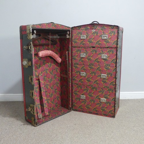 678 - An early 20th century metal bound steamer Wardrobe Trunk, the trunk with brass locks and leather han... 