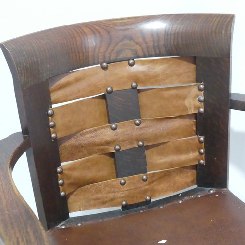 588 - A Glasgow School of Arts and Crafts oak and leather Armchair, the design in the style of George Walt... 