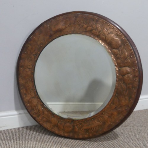 564 - An Arts and Crafts circular oak and copper Mirror, in the manner of Keswick School of Industrial Art... 