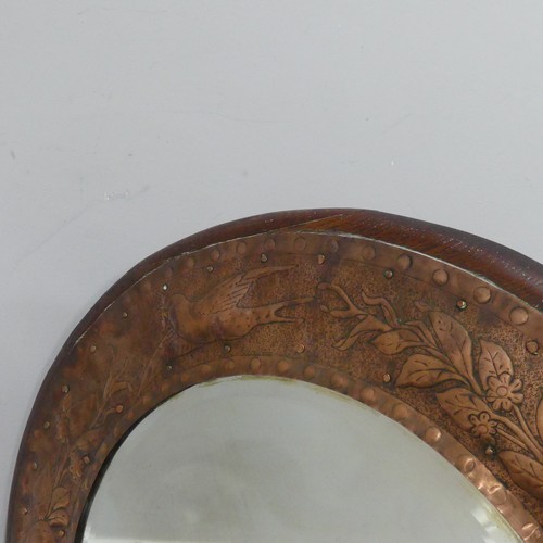 564 - An Arts and Crafts circular oak and copper Mirror, in the manner of Keswick School of Industrial Art... 