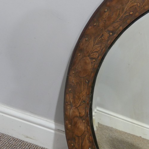 564 - An Arts and Crafts circular oak and copper Mirror, in the manner of Keswick School of Industrial Art... 