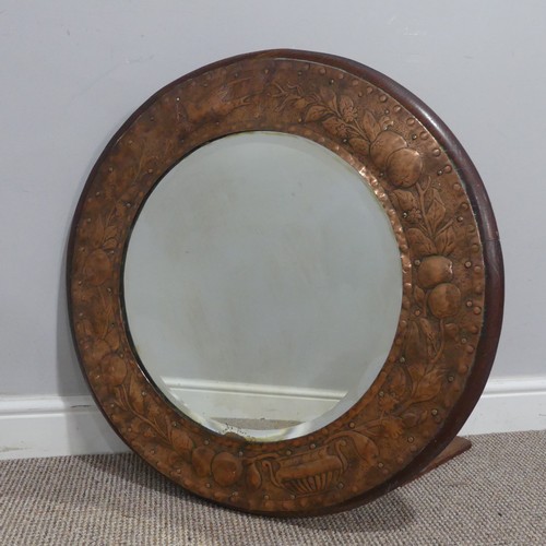 564 - An Arts and Crafts circular oak and copper Mirror, in the manner of Keswick School of Industrial Art... 