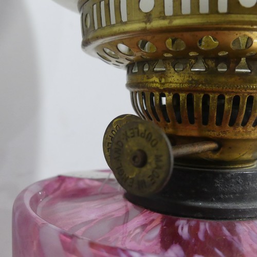 509 - A Victorian cranberry glass oil Lamp, with etched glass shade and stamped 'Made in England', H 56 cm... 