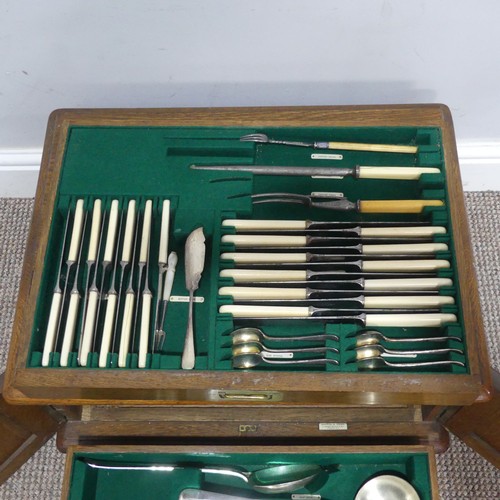 548 - An early 20thC oak Mappin and Webb Canteen of silver plated cutlery, with brass campaign inset handl... 