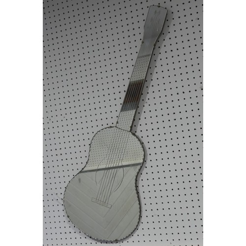 681 - A contemporary guitar shaped Mirror, L 102 cm.