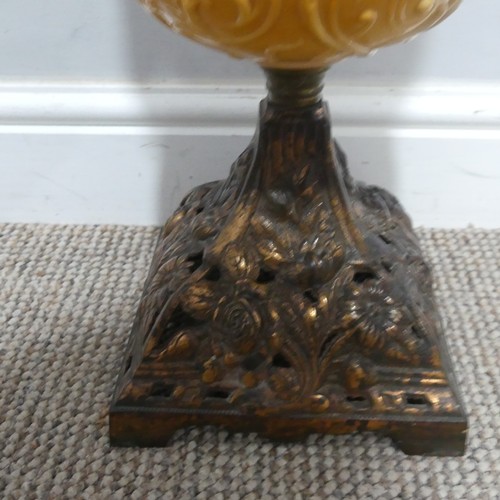 682 - An Art Nouveau Oil Lamp, with orange glass reservoir decorated with stylised flowers, complete with ... 