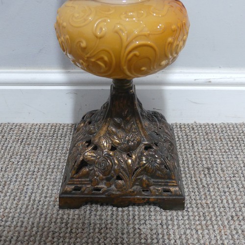 682 - An Art Nouveau Oil Lamp, with orange glass reservoir decorated with stylised flowers, complete with ... 